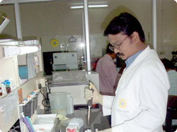 A man in a laboratory using a pipette
